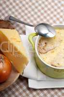 onion soup with melted cheese and bread on top