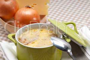 onion soup with melted cheese and bread on top