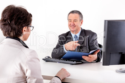 Businessman and businesswoman with documents in the office