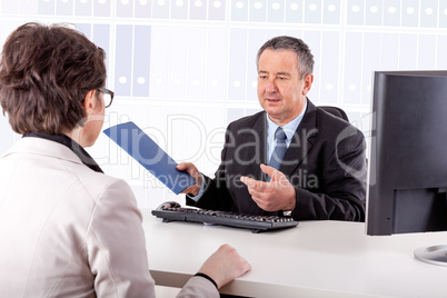 Businessman and businesswoman discuss business