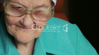 portrait of old reading woman in glasses
