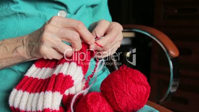 closeup of old womans hands knitting