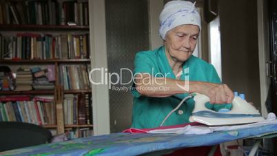 old woman at ironing board