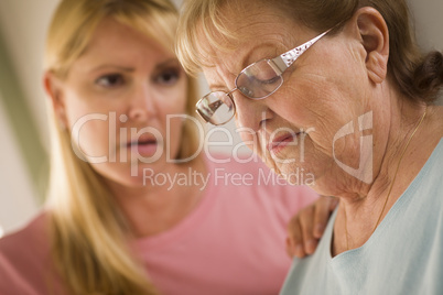 Young Woman Consoles Senior Adult Female