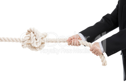 business man hand holding or pulling rope with tied knot