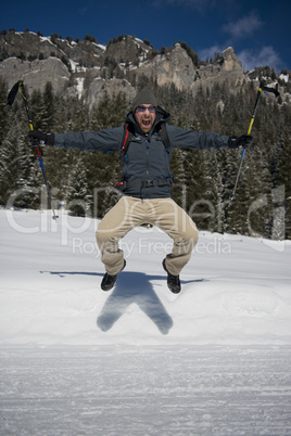 Hiker Jumping on a snowy Trail