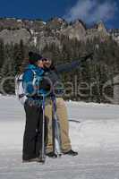 Couple of Hikers Pointing the Way on a snowy Trail