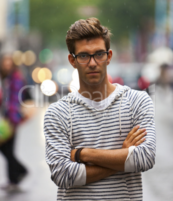 Serious looking young man on street