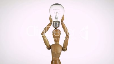 Wooden dummy thinking with idea bulb