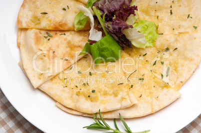 garlic pita bread pizza with salad on top