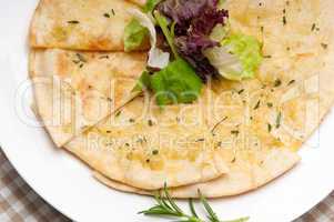 garlic pita bread pizza with salad on top