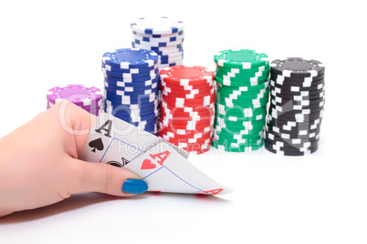 Hand with two Aces and Stacks Poker Chips