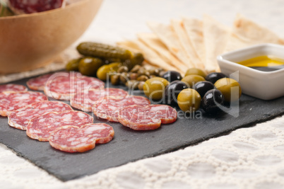 cold cut platter with pita bread and pickles