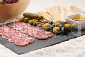 cold cut platter with pita bread and pickles