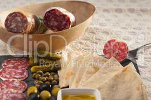 cold cut platter with pita bread and pickles