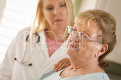 Senior Adult Woman Being Consoled by Female Doctor or Nurse