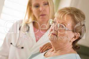 Senior Adult Woman Being Consoled by Female Doctor or Nurse