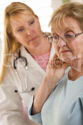 Senior Adult Woman Being Consoled by Female Doctor or Nurse