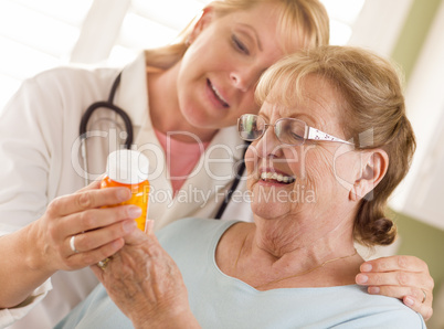 Female Doctor or Nurse Explaining Prescription to Senior Adult W