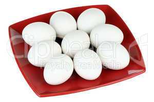 White eggs and red plate