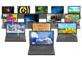 many laptops with different pictures on the screen