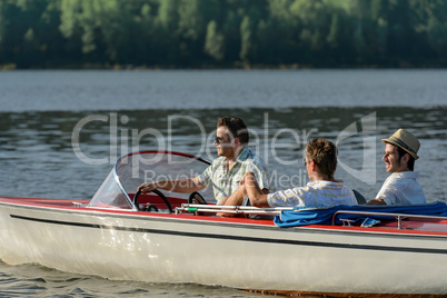 Men driving speed boat enjoying sunshine