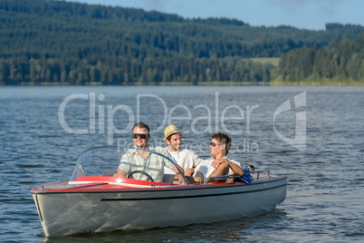 Young men sitting in motorboat scenic landscape