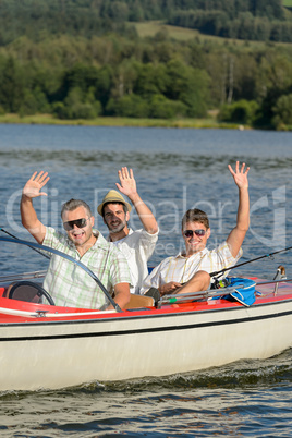Cheerful young men sitting in motorboat