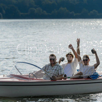 Cheerful young men drink beer speed boat