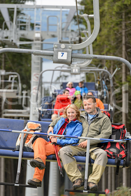Lovely couple sitting on chairlift