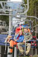 Lovely couple sitting on chairlift