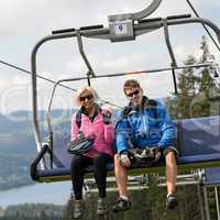 Young couple sitting on chairlift