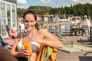 Woman drinking cocktail at beach bar