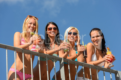 Beautiful women in bikinis smiling with drinks