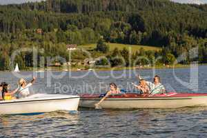 Young friends having fun in motorboats