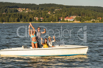 Young friends enjoying summer on speed boat