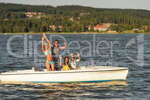 Young friends enjoying summer on speed boat