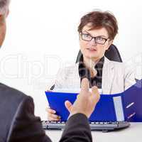 Business woman with folder speaks to man in a suit