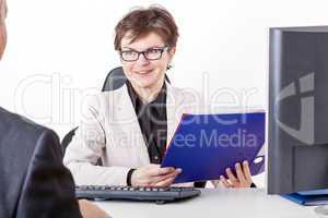 Business woman with folder speaks to man in a suit