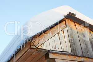 Roof of rustic wooden with snow