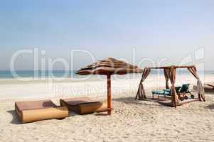 Beach with hut and sunbeds of the luxury hotel, Ajman, UAE