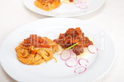 pasta with pork ribbs sauce on polenta bed