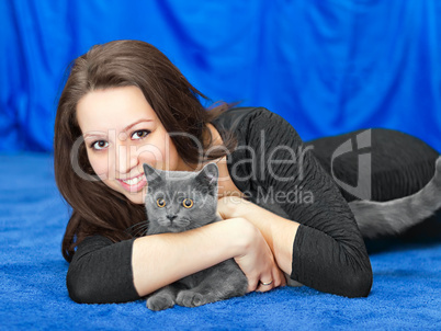 beautiful girl with a cat on hands