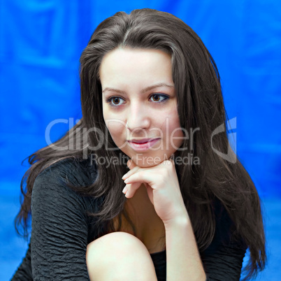 portrait of a young girl on blue background