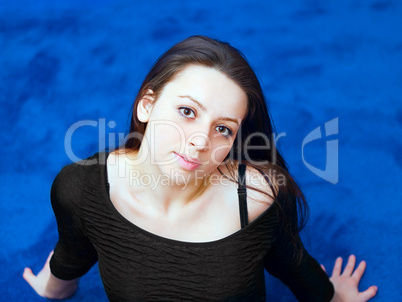 portrait of a young girl on blue background