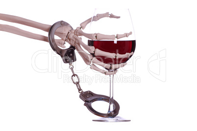 skeleton hand with wine and handcuff