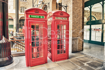 london, uk. old red telephone booth on a city street