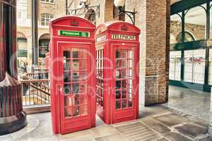 london, uk. old red telephone booth on a city street