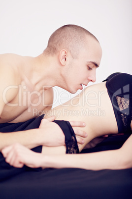 muscular man kisses the girl in underwear