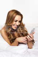 woman with a joyful smile reading a text message